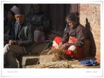 Men sitting with nothing to do, while women busy working: a common scene in the villages